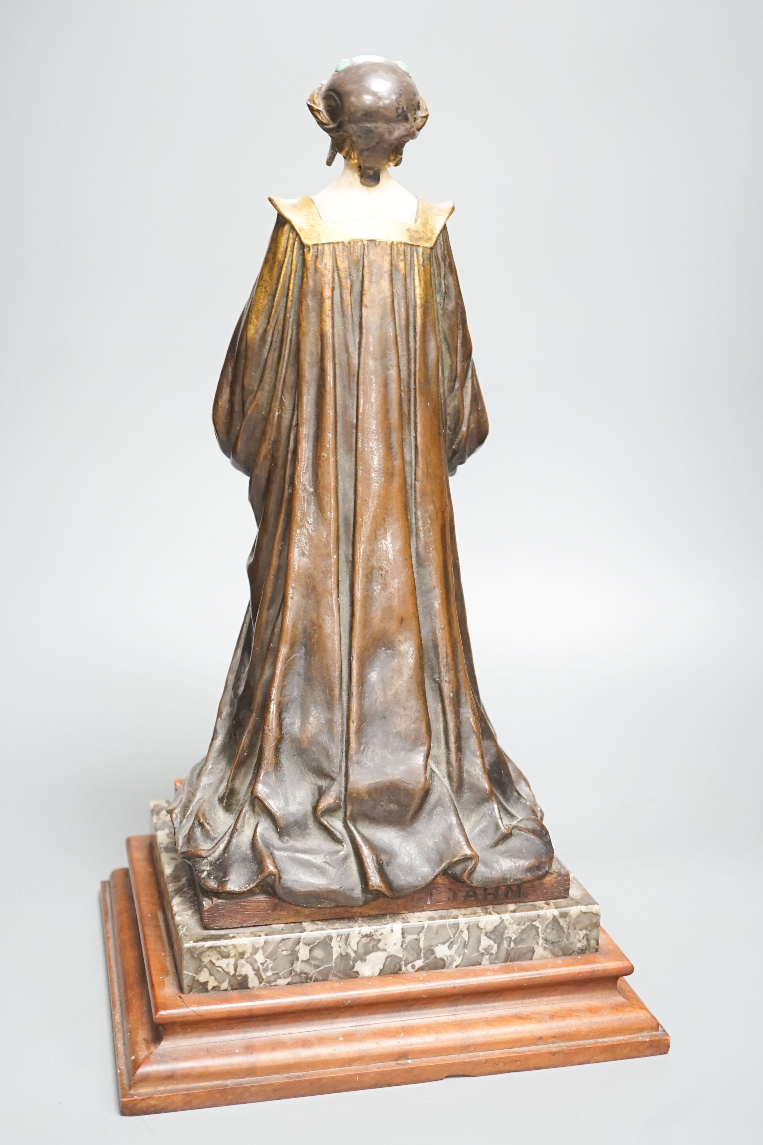 A German Art Nouveau bronze and ivory figure of Pandora, with inset carved ivory head and hands on polished stone and cut wood base, signed F. Jahn, 41cm high